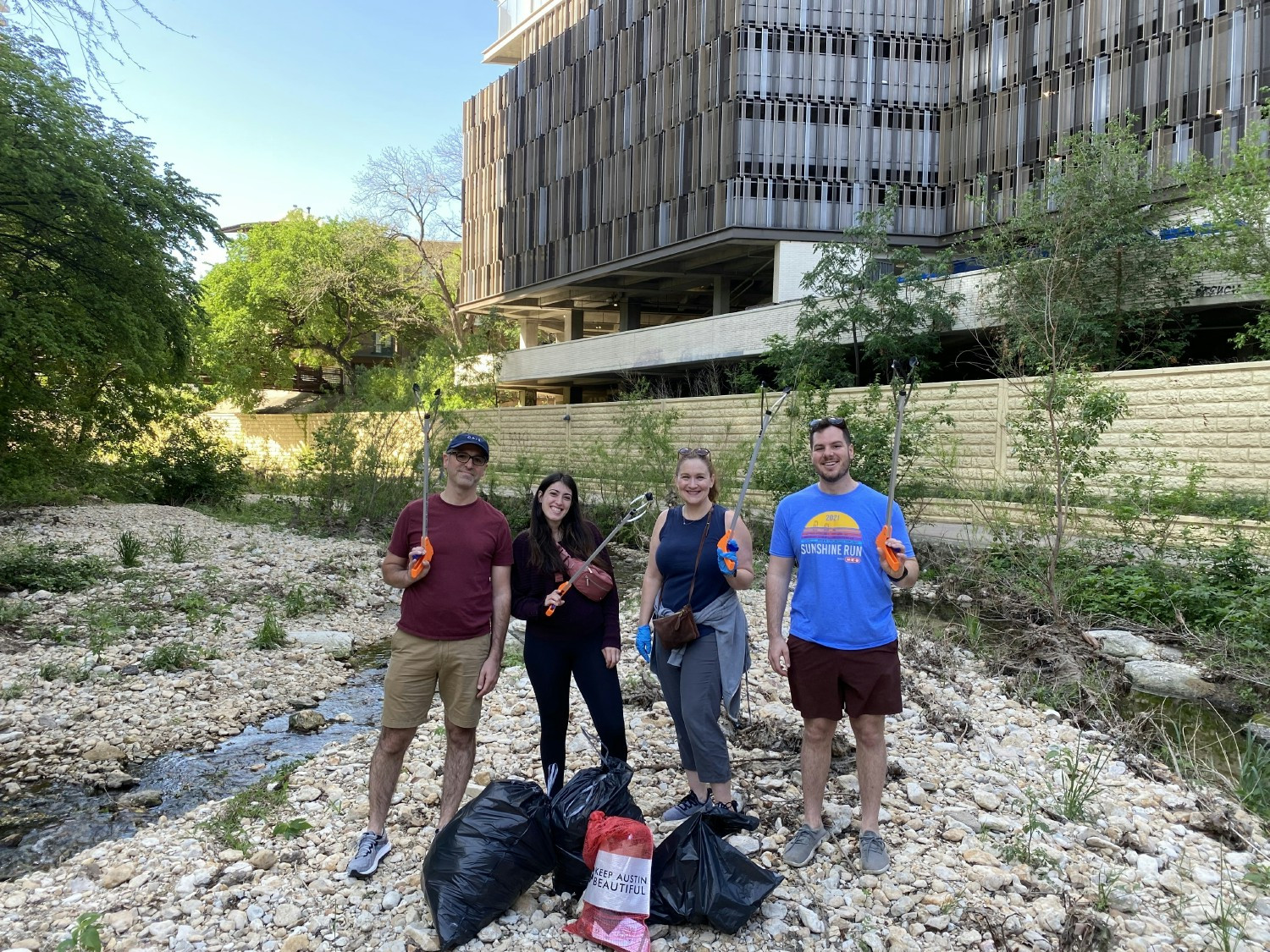 Colleagues in Austin, Texas volunteer for the 2023 Keep Austin Beautiful Creek Cleaning initiative 